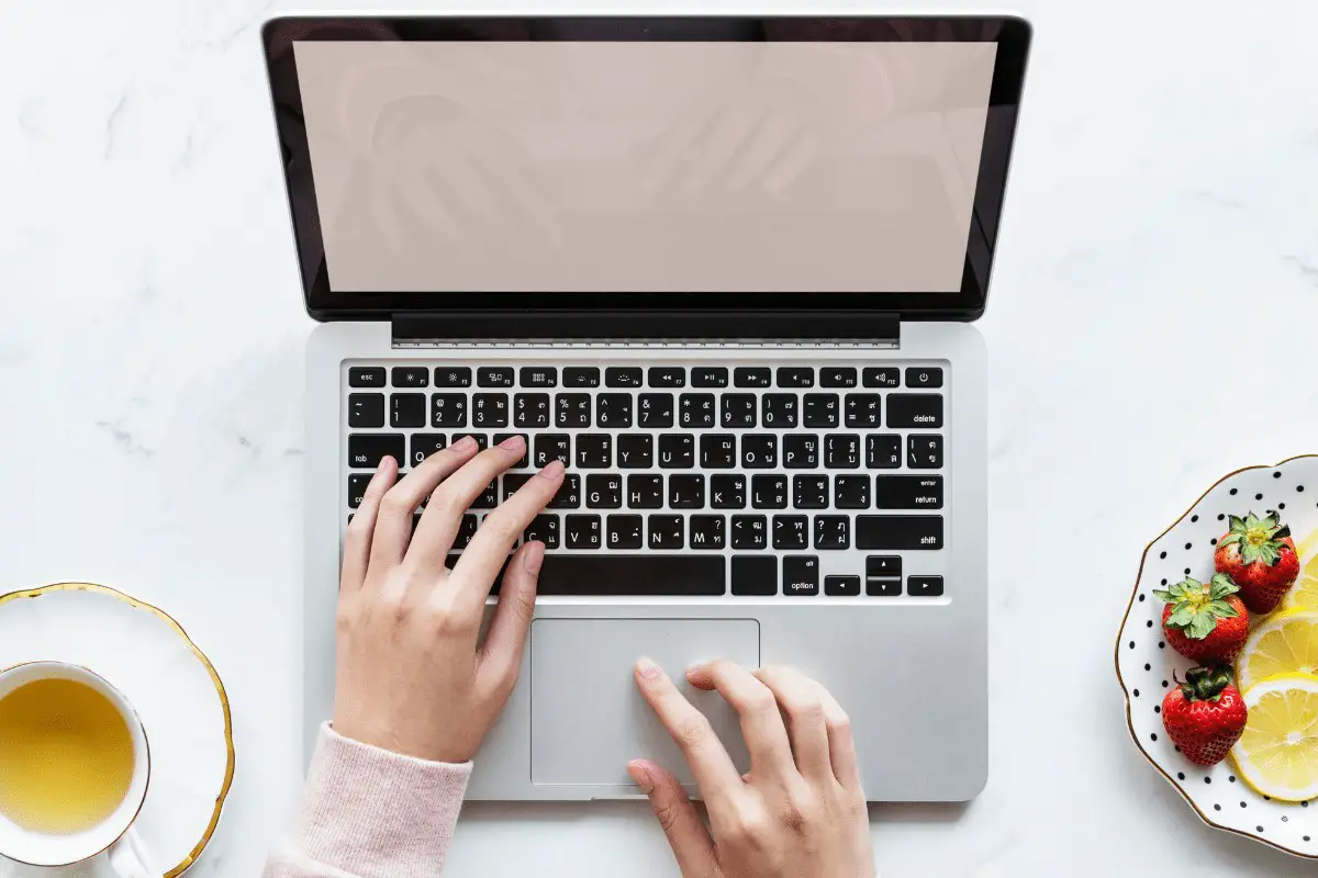 hands typing on a laptop computer