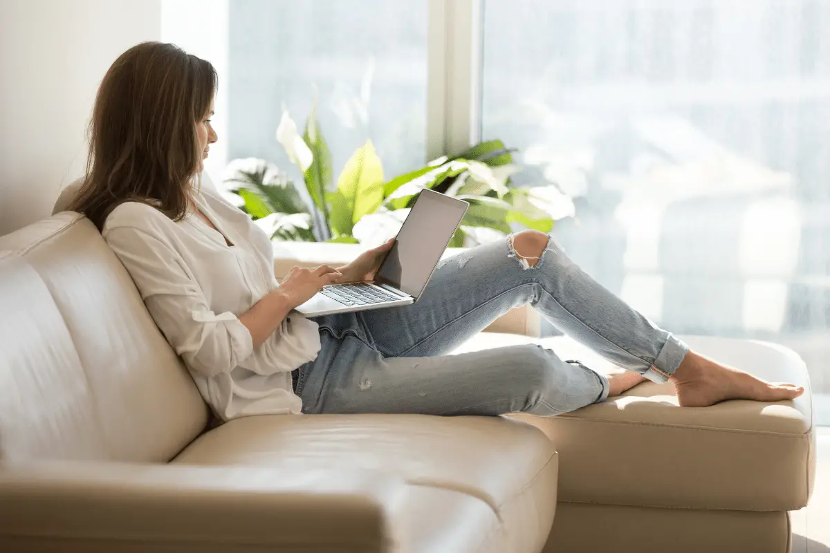 picture of woman sitting on couch searching the web