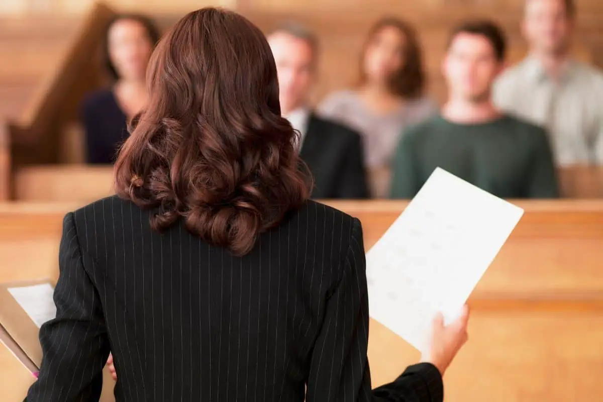 back of a woman's head in a room of people