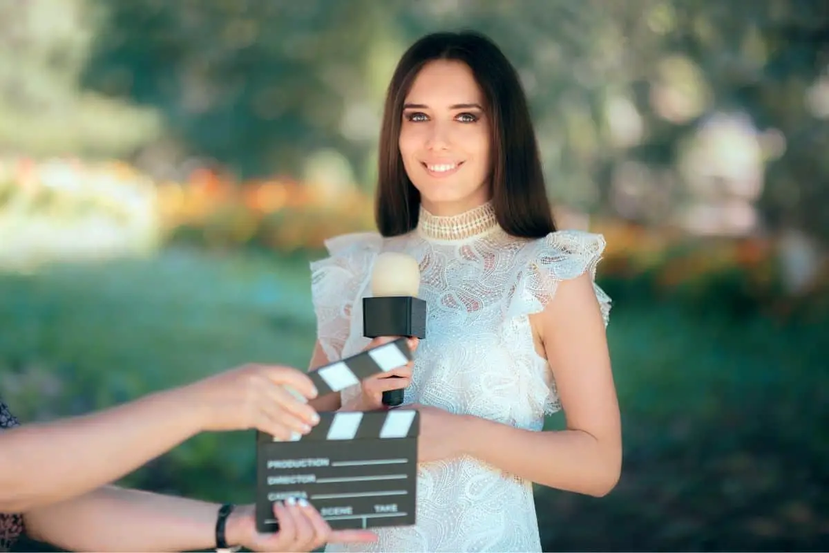 woman wearing a white dress holding a microphone