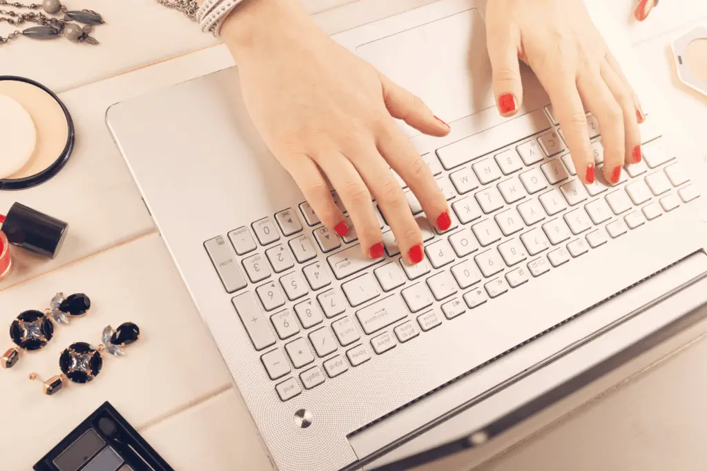 woman typing on macbook