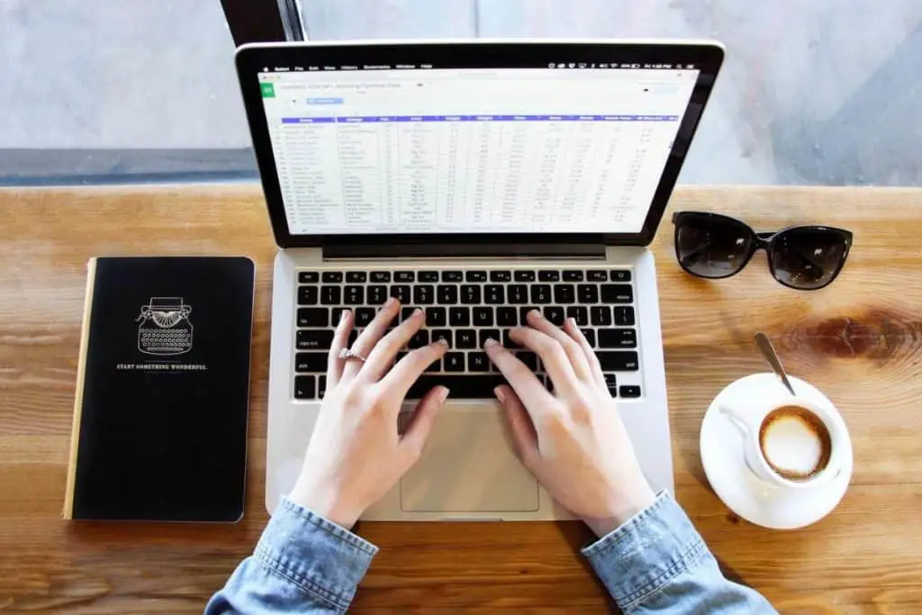 woman typing on MacBook