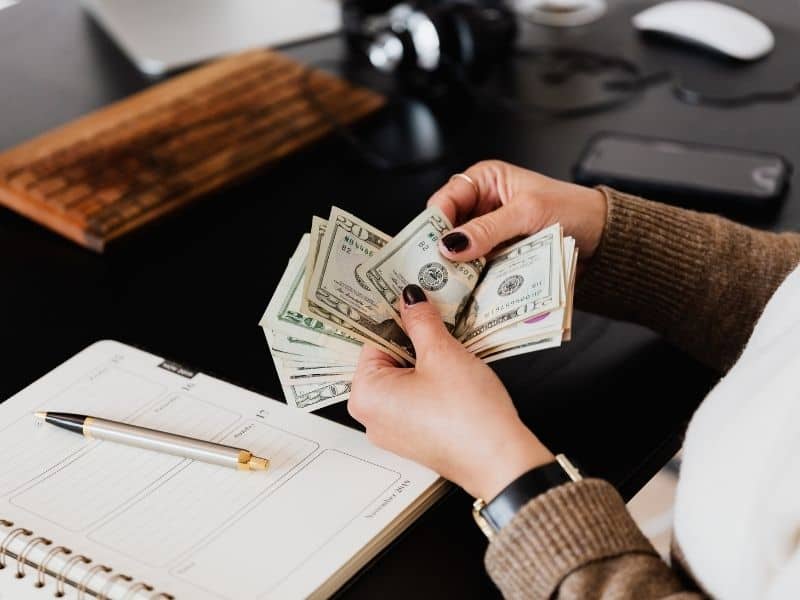 a woman's hands counting money