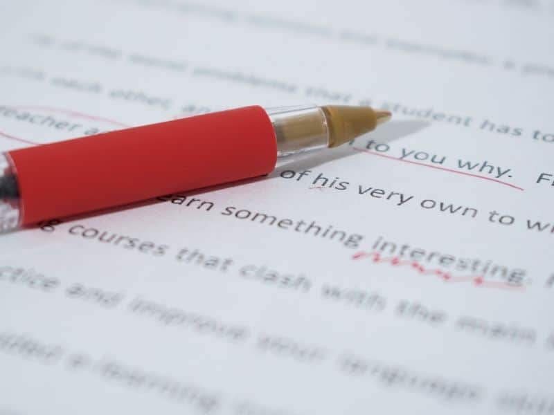 red pen on a piece of text covered paper