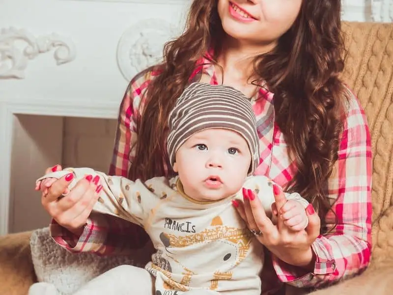 a woman holding a baby on her lap