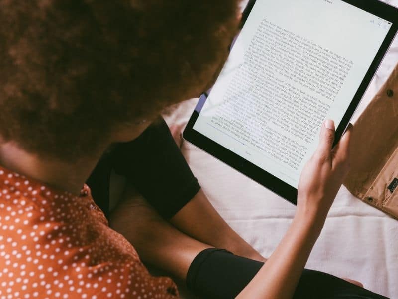 a woman reading a kindle