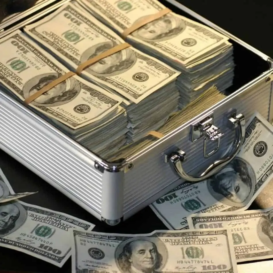 a white box of money with bills spilling out
