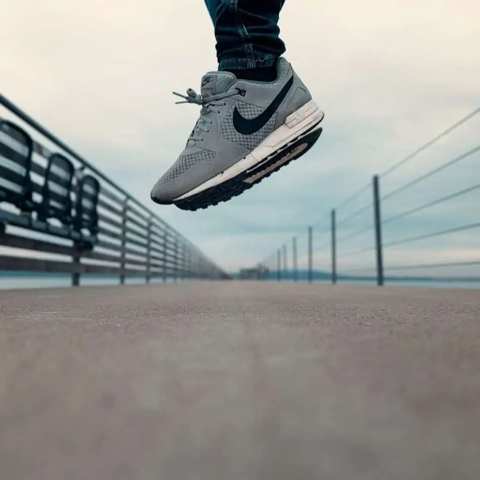 a person in nike sneakers jumping