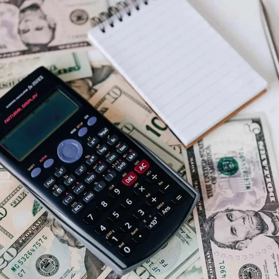 calculator and money with a notebook