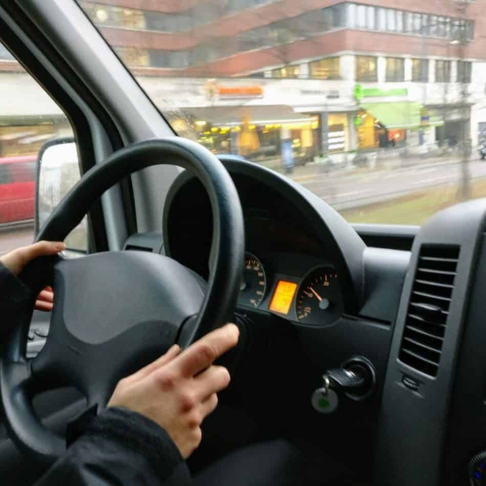 hands on a steering wheel in a car