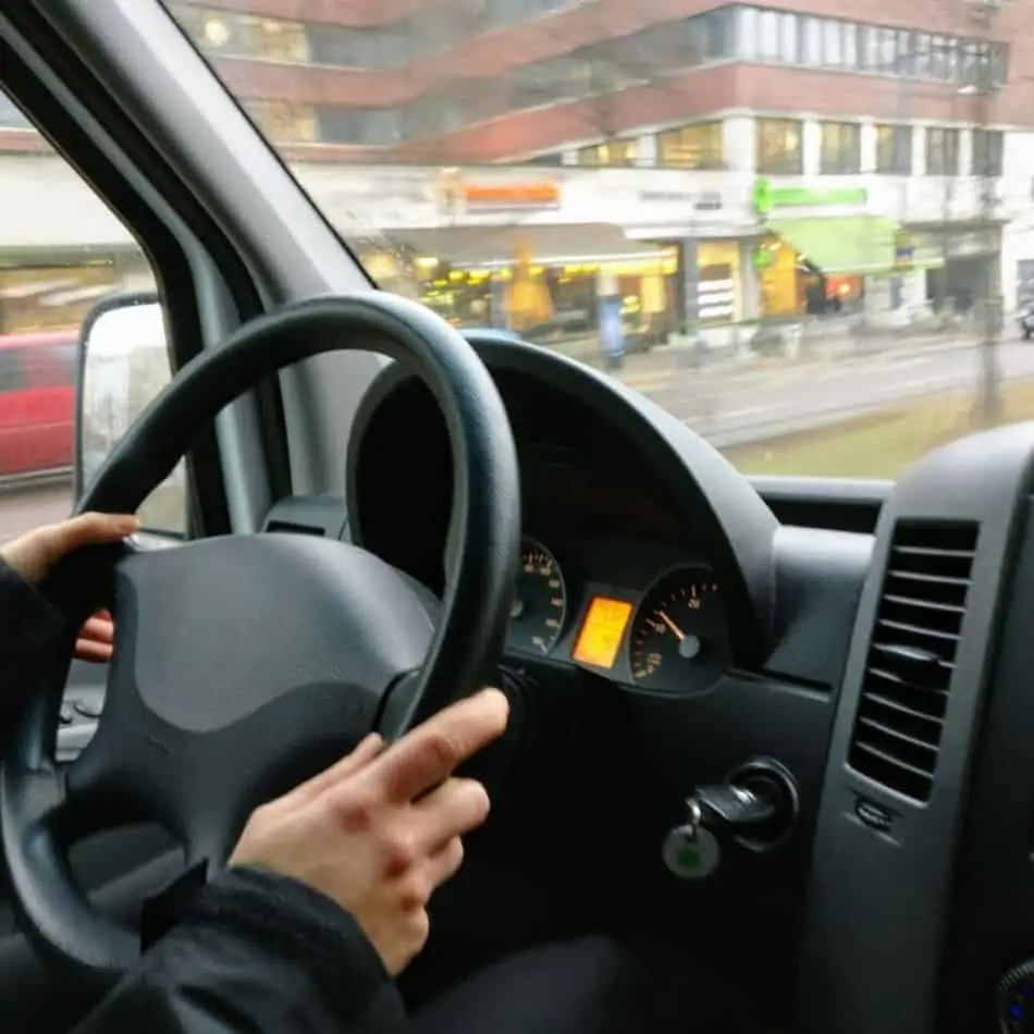 hands on a steering wheel in a car