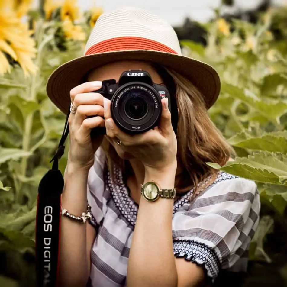 a woman point a camera at the camera