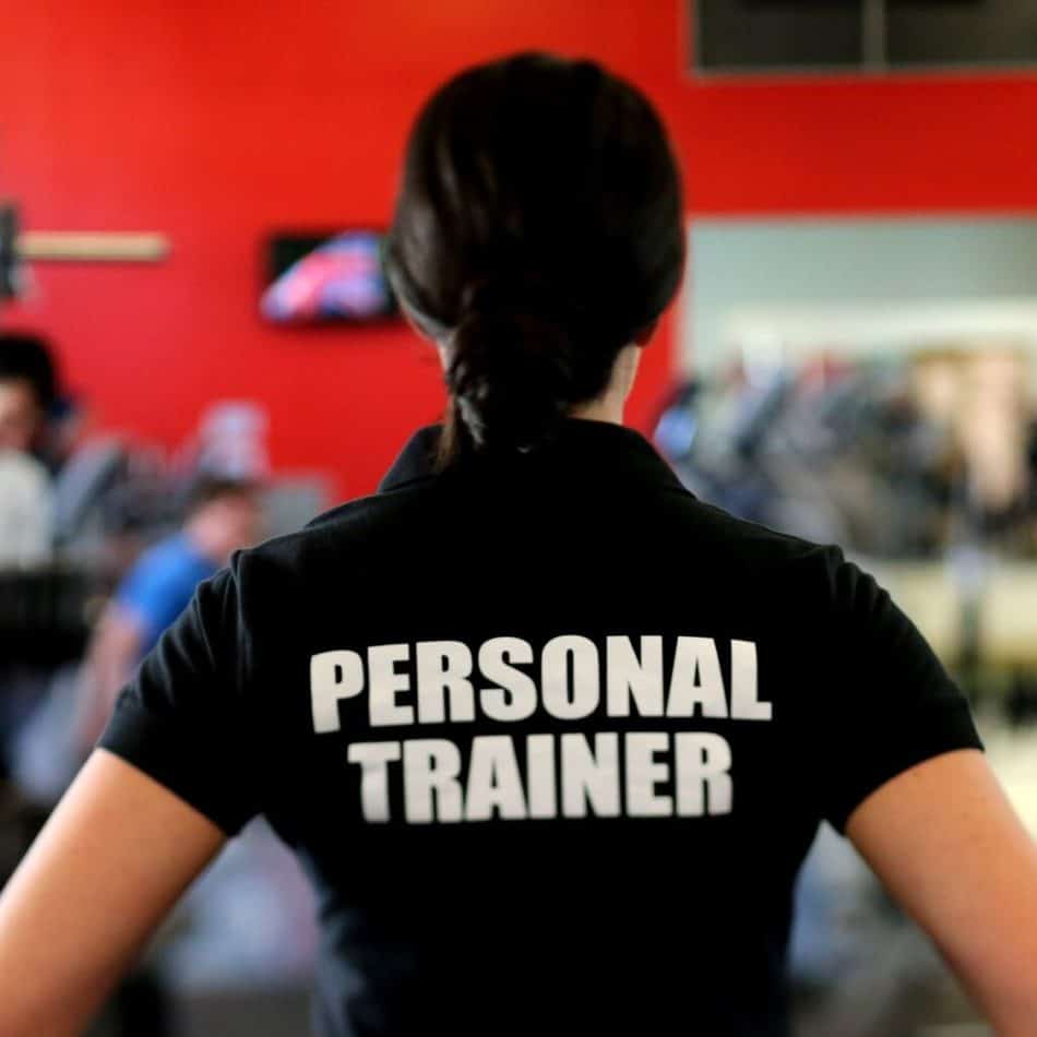 a personal trainer in a black shirt with her back turned