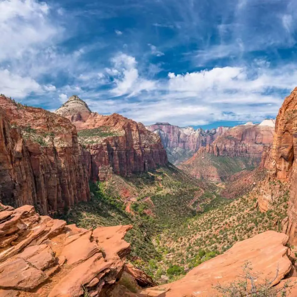 a mountainous canyon with green at the bottom